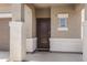 Covered front porch area featuring decorative columns and a dark wood front door with sidelight at 4527 E Gagarinite Ln, San Tan Valley, AZ 85143