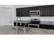 Modern kitchen with stainless steel appliances, dark wood cabinets, and granite countertops, offering style and functionality at 4527 E Gagarinite Ln, San Tan Valley, AZ 85143