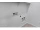 This laundry room includes hookups for a washer and dryer with a small shelf at 4527 E Gagarinite Ln, San Tan Valley, AZ 85143