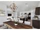 Open-concept living space with dining area, kitchen island, and comfortable seating, perfect for entertaining at 4527 E Gagarinite Ln, San Tan Valley, AZ 85143