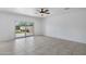 Spacious living room featuring tile floors, a ceiling fan, and access to the backyard at 4527 E Gagarinite Ln, San Tan Valley, AZ 85143