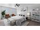 Staged bedroom features two windows, ceiling fan, and modern decor at 4527 E Gagarinite Ln, San Tan Valley, AZ 85143