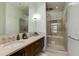 Well-lit bathroom features double sinks, modern lighting, and large walk-in shower with separate bathtub at 4747 N Scottsdale Rd # 4009, Scottsdale, AZ 85251