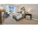 Cozy bedroom with a large window allowing for plenty of natural light and an accent chair at 477 E Aurora Dr, San Tan Valley, AZ 85140