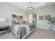 Spacious bedroom with neutral tones, modern light fixture, and a decorative sliding door at 477 E Aurora Dr, San Tan Valley, AZ 85140