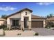 Charming single-story home with stone accents, desert landscaping, and a covered front porch at 477 E Aurora Dr, San Tan Valley, AZ 85140