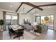 Open-concept living and dining area with vaulted ceilings, wood beams, and abundant natural light at 477 E Aurora Dr, San Tan Valley, AZ 85140