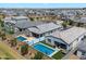 Aerial view of two homes featuring pools, spas, and outdoor living spaces in a well-kept neighborhood at 5341 W Alta Mesa Ave, Laveen, AZ 85339