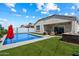 Inviting backyard featuring a sparkling pool, spa, and comfortable patio seating under string lights at 5341 W Alta Mesa Ave, Laveen, AZ 85339