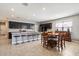 Kitchen and dining area, stainless appliances, tile floors, dark cabinets, and breakfast bar at 5341 W Alta Mesa Ave, Laveen, AZ 85339