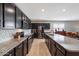 Modern kitchen featuring stainless steel appliances, dark cabinets, and granite countertops at 5341 W Alta Mesa Ave, Laveen, AZ 85339