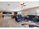 Open floor plan of the kitchen and living room, with tile flooring and comfortable seating at 5341 W Alta Mesa Ave, Laveen, AZ 85339