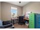 Bright office space with a wooden desk, dual monitors, and natural light from a window at 5341 W Alta Mesa Ave, Laveen, AZ 85339