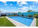 Backyard featuring a swimming pool, artificial turf, landscaping and a blue privacy fence at 5341 W Alta Mesa Ave, Laveen, AZ 85339
