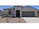 Charming single-story home featuring a stucco facade, arched entryway, and well-manicured desert landscaping at 5827 E Axle Ln, San Tan Valley, AZ 85140