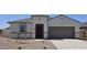 Charming single-story home featuring a two-car garage and desert landscaping for low maintenance at 5827 E Axle Ln, San Tan Valley, AZ 85140