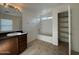 Bright bathroom with a single vanity, shower-tub combo with a window, and large storage closet at 6341 W Valencia Dr, Laveen, AZ 85339