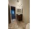 Well-lit bathroom features tiled floors, vanity, and an adjacent bedroom at 6341 W Valencia Dr, Laveen, AZ 85339