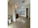 Full bathroom with a dark wood vanity and cabinet, shower-tub combo and separate toilet room at 6341 W Valencia Dr, Laveen, AZ 85339