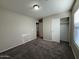 This bedroom features plush carpeting, neutral walls, and a closet at 6341 W Valencia Dr, Laveen, AZ 85339