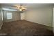 Large empty bedroom with carpet, ceiling fan and windows at 6341 W Valencia Dr, Laveen, AZ 85339