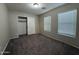 Bedroom featuring neutral carpet, two windows, and a closet at 6341 W Valencia Dr, Laveen, AZ 85339