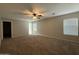 Spacious carpeted bedroom with ceiling fan and natural light at 6341 W Valencia Dr, Laveen, AZ 85339