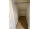View of closet with bar and neutral tile flooring at 6341 W Valencia Dr, Laveen, AZ 85339