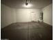 View of an empty garage with a door to the house at 6341 W Valencia Dr, Laveen, AZ 85339