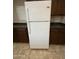 The kitchen shows a white refrigerator, dark cabinets, and countertops against a tile floor at 6341 W Valencia Dr, Laveen, AZ 85339