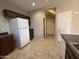 Bright kitchen with brown cabinetry, tile flooring and white appliances at 6341 W Valencia Dr, Laveen, AZ 85339