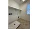 Functional laundry room includes tile floor, shelving and all necessary hookups at 6341 W Valencia Dr, Laveen, AZ 85339