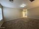 Spacious carpeted living room with a neutral color palette and natural light at 6341 W Valencia Dr, Laveen, AZ 85339