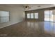Bright living room with tile floors, large windows with privacy blinds, and sliding glass door leading to outdoor area at 6341 W Valencia Dr, Laveen, AZ 85339