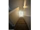 Carpeted staircase leading down features neutral walls and handrail at 6341 W Valencia Dr, Laveen, AZ 85339