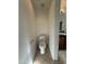 Compact toilet space featuring tile flooring and a clean, modern toilet at 6341 W Valencia Dr, Laveen, AZ 85339