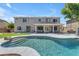 Large backyard features in-ground pool, covered porch, and 2-story house at 7129 S Stadium Way, Gilbert, AZ 85298