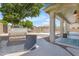 Covered outdoor kitchen features built-in BBQ, blue patterned rug, and views of the pool at 7129 S Stadium Way, Gilbert, AZ 85298