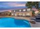 The backyard offers a private pool and a covered patio and is ideal for entertaining at 7129 S Stadium Way, Gilbert, AZ 85298