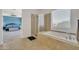 Bright bathroom with a soaking tub, glass-enclosed shower, and views of the main bedroom at 7129 S Stadium Way, Gilbert, AZ 85298