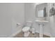 Stylish powder room with a white pedestal sink and modern toilet at 7129 S Stadium Way, Gilbert, AZ 85298
