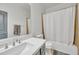 Clean bathroom featuring a vanity with a quartz countertop and a shower-tub combination at 7129 S Stadium Way, Gilbert, AZ 85298