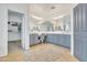 Bright bathroom featuring double vanity, large mirrors, stylish blue cabinets, and walk-in closet at 7129 S Stadium Way, Gilbert, AZ 85298