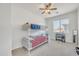 This bedroom features light gray carpet, white walls, a ceiling fan, a window, and a bunk bed at 7129 S Stadium Way, Gilbert, AZ 85298