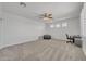 Expansive room with plush carpeting, ceiling fan, neutral walls, and shutters at 7129 S Stadium Way, Gilbert, AZ 85298