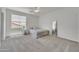 Cozy bedroom with neutral carpet, a window bringing in natural light, and simple furnishings, offers a relaxing retreat at 7129 S Stadium Way, Gilbert, AZ 85298