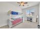 Bright ' bedroom with bunk beds, ceiling fan, and large window providing natural light at 7129 S Stadium Way, Gilbert, AZ 85298
