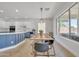 Modern dining room features a wooden dining table, and a view to the kitchen and backyard at 7129 S Stadium Way, Gilbert, AZ 85298