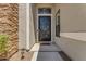 Elegant front door with decorative ironwork, stone accents, and a covered porch area at 7129 S Stadium Way, Gilbert, AZ 85298