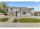 Beautiful two story home featuring stone accents, nice lawn, and a walkway leading to the front door at 7129 S Stadium Way, Gilbert, AZ 85298